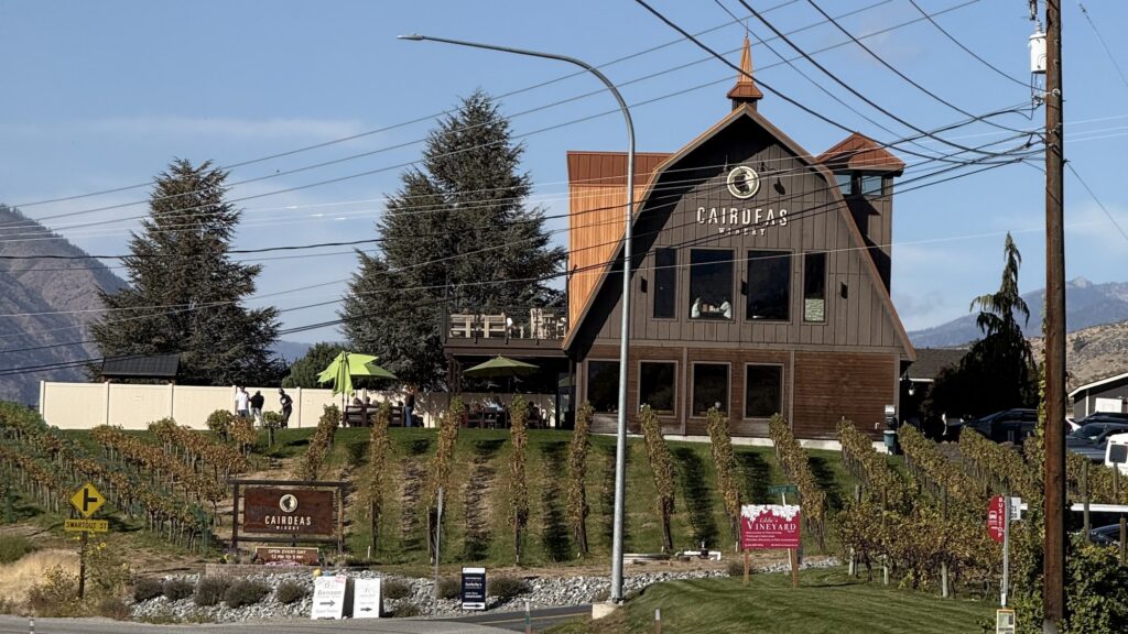 Cairdeas Winery on Manson Highway in the Lake Chelan Valley, a barn-style tasting room above rows of vineyard vines